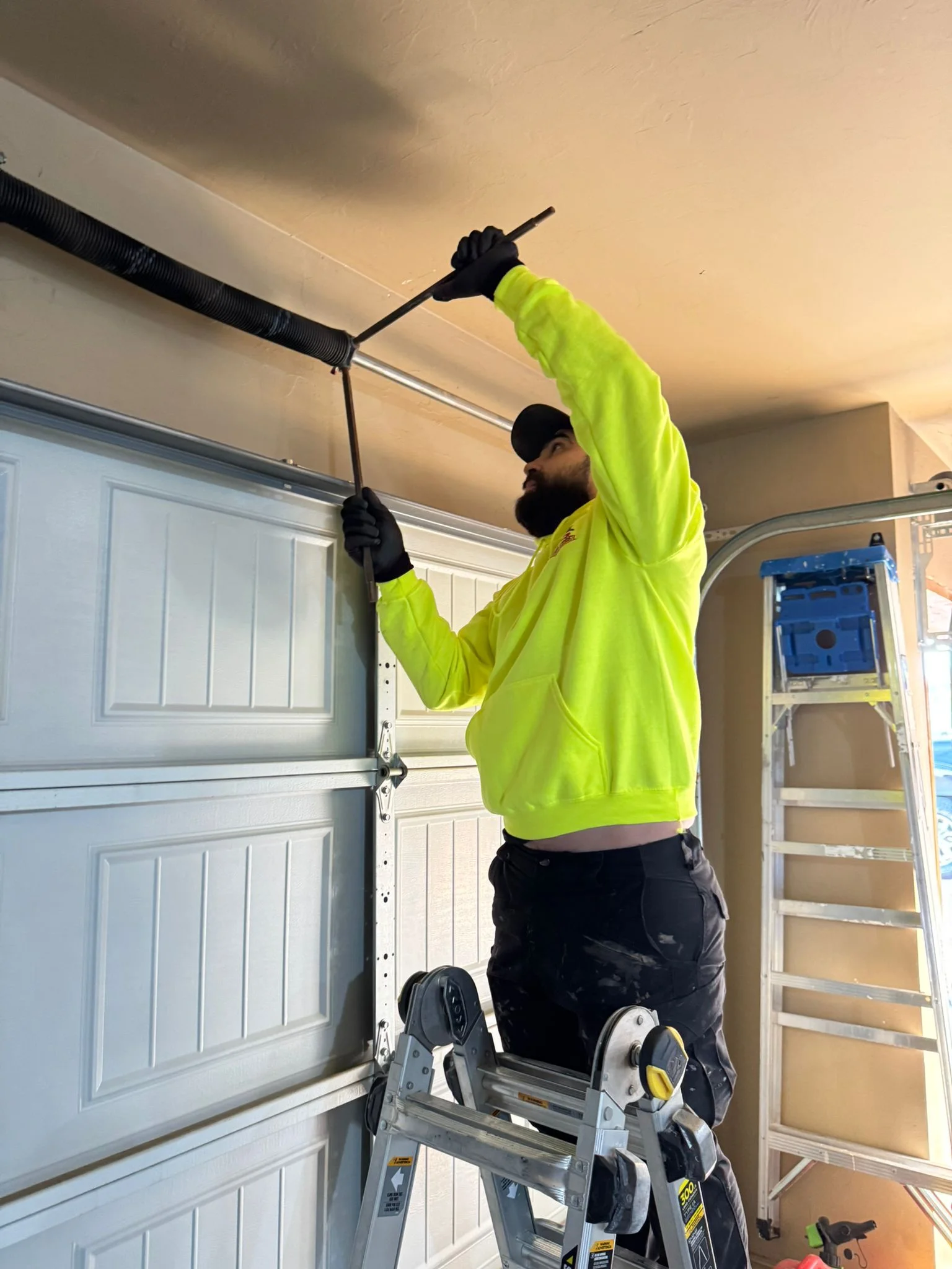 Broken garage door spring replacement by 405 Garage Pros technician